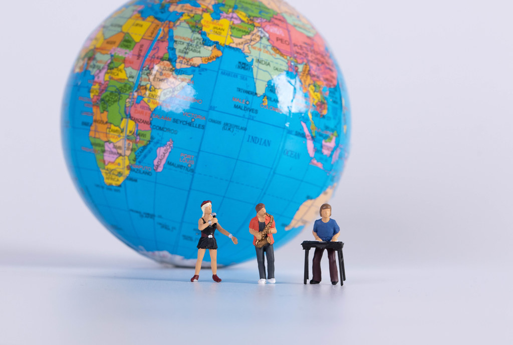 Miniature band with globe in the background Miniature band with globe in the background
