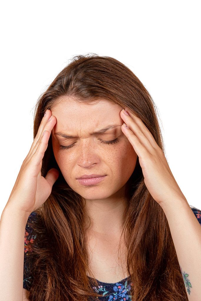 Teen woman with headache holding her hand to the head Teen woman with headache holding her hand to the head